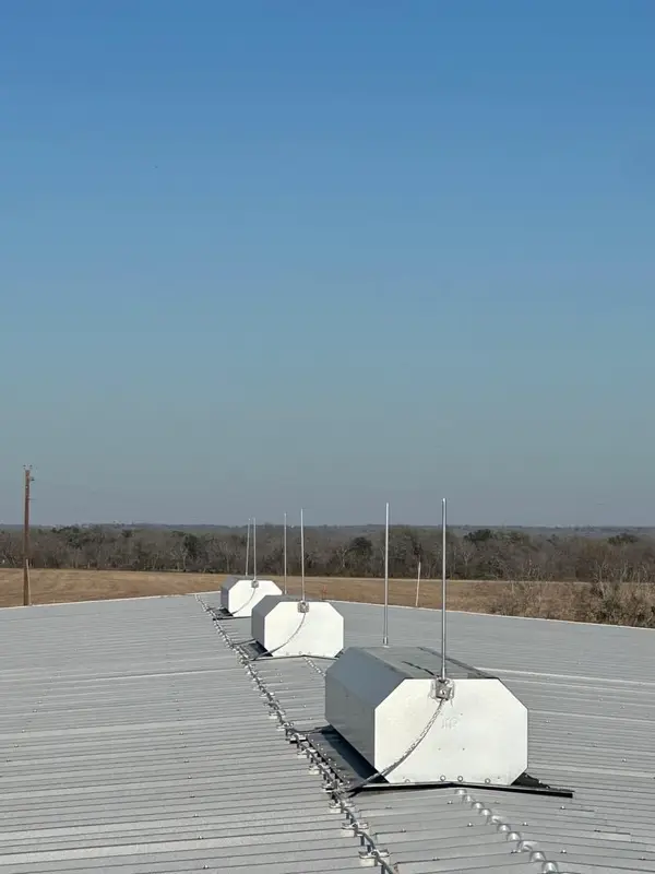 Harger lightning protection air terminals on metal building roof in Staples TX — installed by Cross Texas Electric